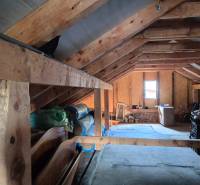 Attic of a family house with wooden beams and storage space.