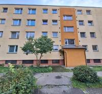 A four-story apartment building surrounded by greenery in Martin, offering 3-bedroom apartments.