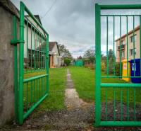 The green gate leads to the lawn near Matica Slovenská in the town of Veľký Šariš.
