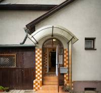 Entrance to the house with a glass canopy on Matice Slovenskej, Veľký Šariš, leading to a 3-room apartment.