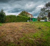 The garden on Matice Slovenskej Street in Veľký Šariš surrounded by greenery and buildings.