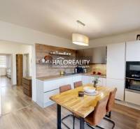 Kitchen in a 3-room apartment with a dining area, open space, floor with wood decor.