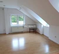 An attic room with a wooden decor floor in a 2-room apartment.