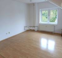 A room in a 2-room apartment with a wooden decor floor and a window.