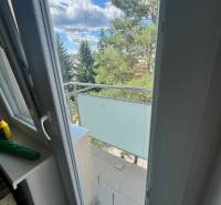 View from the balcony in a 3-room apartment with a wooden decor floor.