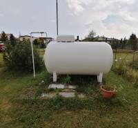 Garden plot in Turčianske Teplice with a gas tank and surrounding greenery.