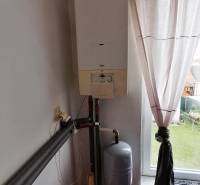 Heating in a 3-room apartment with curtains and a garden view.