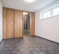 An empty room with a built-in wardrobe and a wooden decor floor in a 2-room apartment.
