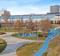 A park with walkways, greenery, and exercise zones on Trnavská cesta street.