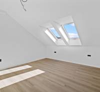 Attic room with wooden floor and skylights on Trnavská Street.