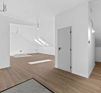 Modern interior of a white room in a 3-room apartment with wooden flooring, on Trnavská cesta street.