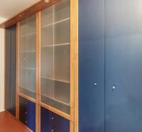 A built-in wardrobe with blue doors and a wooden frame in a 3-room apartment.