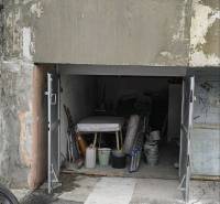 Garages on Dudvážska Street in Bratislava - Podunajské Biskupice with an open gate and various items.