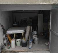 An open garage on Dudvážska Street in Bratislava - Podunajské Biskupice, full of tools and materials.
