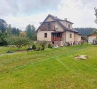 A family house in Liptovská Porúbka with a large garden and fruit trees.