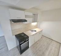 A kitchen unit with a wooden decor floor in a 3-room apartment.