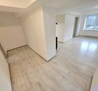 Interior of a 3-room apartment with a wooden decor floor and a large window.