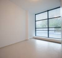 A spacious room with a large window and blinds in a 4-room apartment.