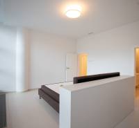 Bedroom in a 4-room apartment with a bed, window, and entrance to the bathroom.