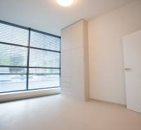 A room with large windows, a built-in wardrobe, and blinds in a 4-room apartment.