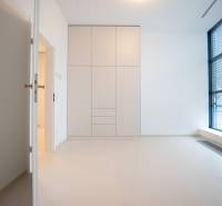 A bright room with a large window and a built-in wardrobe in a 4-room apartment.