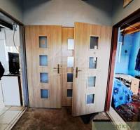 Interior of a family house with double doors and laminate flooring.