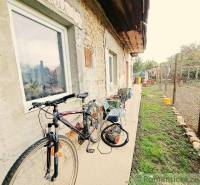 Bicycle and tools at a family house with a stone facade in Ľudovítová.