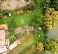 Aerial view of a waterfront property with nature in Ľudovítová.