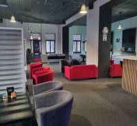 Commercial spaces with sofas and games, including table football and darts.