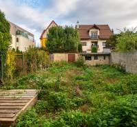 The garden of a family house on Sreznevského Street in Bratislava - Nové Mesto, surrounded by vegetation.