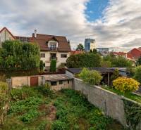 A family house on Sreznevského Street, Bratislava - Nové Mesto, surrounded by garden greenery and neighboring houses.