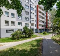A panel apartment building surrounded by greenery on Pribišova Street in Bratislava - Karlova Ves.
