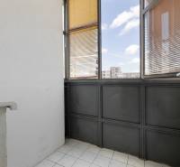 Glazed loggia with white tiles in a 3-room apartment.