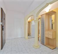 Entrance hall with arches, a mirror, and a built-in wardrobe in a 3-room apartment.