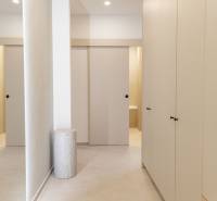 A hallway with tiles and built-in wardrobes in a 4-room apartment.