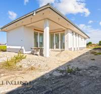 A family house in Gabčíkovo, under construction, with a white facade and large windows.