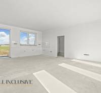 The interior of a family house with white walls and large windows. Ready for completion.