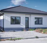 A family house in Slovenská Nová Ves on Slovenská Nová Ves street with a dark roof and parking lot.