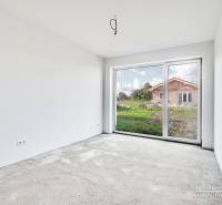 Empty room with a concrete floor and a large window in a family house.