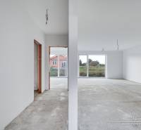 An empty interior in a family house with a view of a large window and an entrance area.