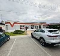 Commercial premises at Štefánikova 267 in Palárikovo with a parking lot and two cars.