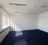 Offices with a light carpet and white blinds, entrance to the area with a sink.