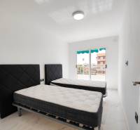 Two beds with dark headboards in the bedroom of a three-room apartment.