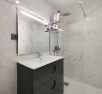 Bathroom in a 3-room apartment with white tiles and a shower corner.