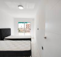 A bright bedroom with two beds in a 3-room apartment.