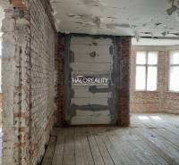 Interior of a family house with exposed brick walls and a wooden decor floor.