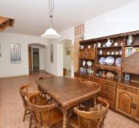 A dining room in a family house with wooden furniture and decorative ceramic accessories.