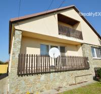 A family house in Hegyeshalom with a balcony, satellite, and stone cladding on the facade.