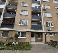 Apartment building on SNP Street in Šahy with balconies and a flower front garden.
