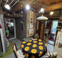 A cottage with a dining table and Christmas decorations, wooden decor of the ceiling and walls.